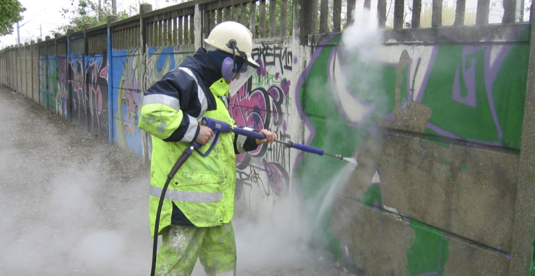 graffiti removal being done on a house in h2x